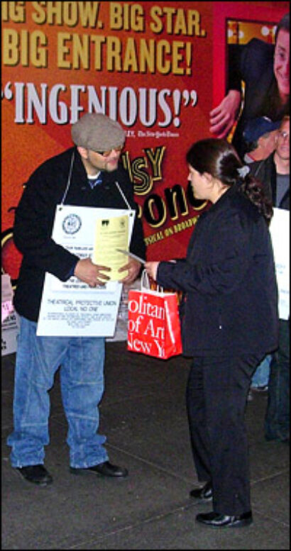 A union member hands out flyers.