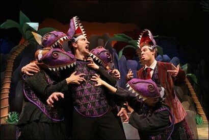 From Left: Ben Dibble and Joshua Lamon with T-Rexes in <i>The Dinosaur Musical</i>.