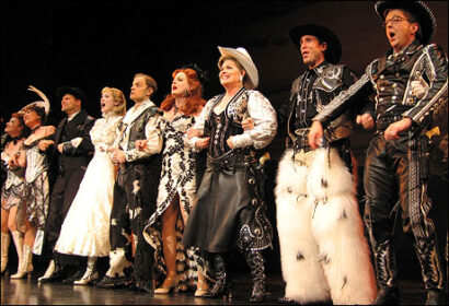 The company of <i>Curtains</i> takes their opening night bows.